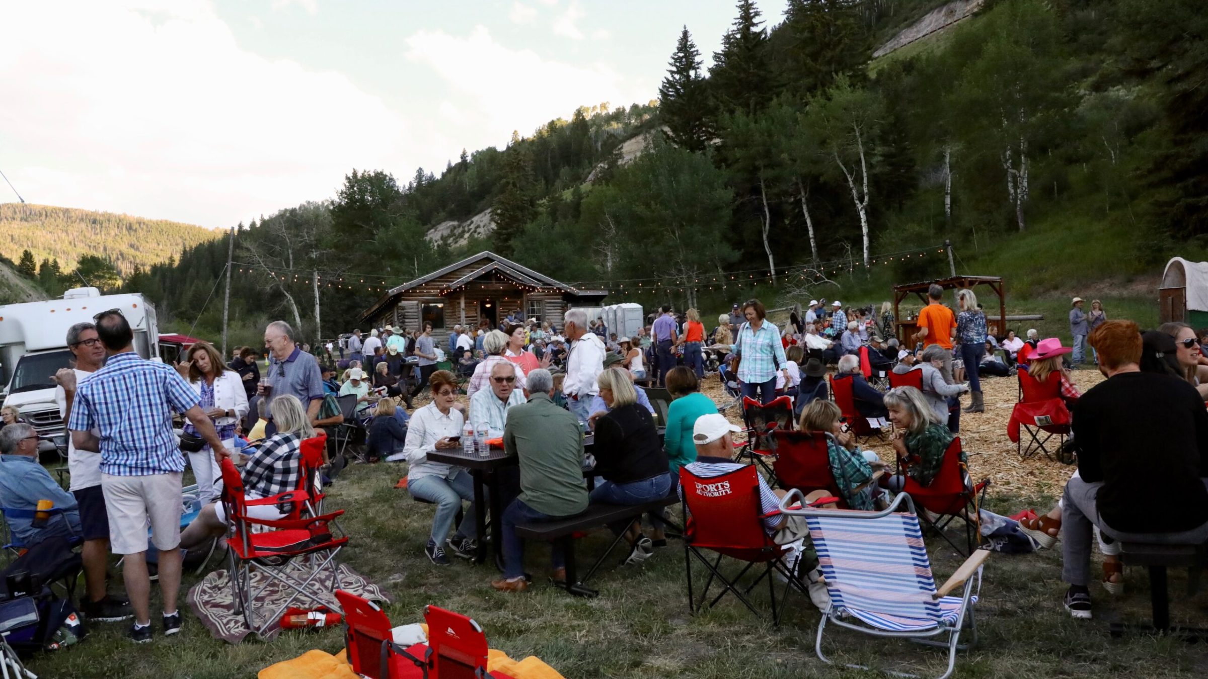 a group of people sitting at a picnic table