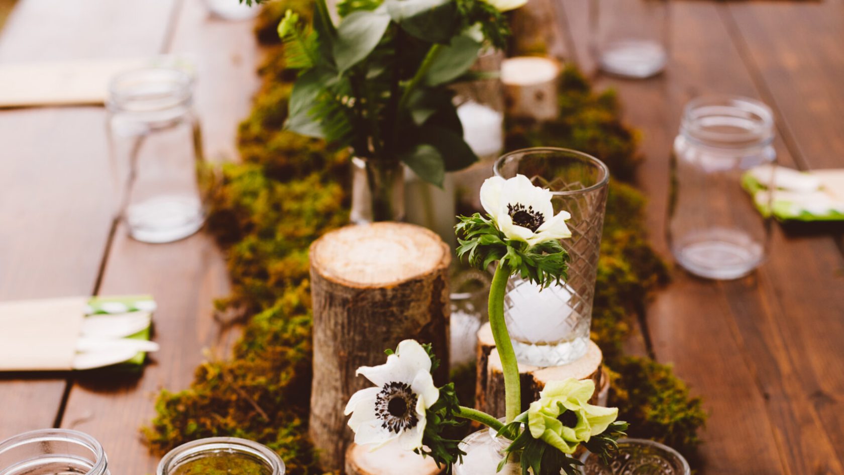 a vase of flowers sitting on top of a wooden table