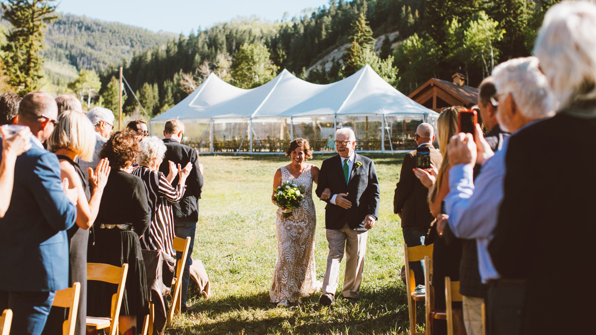 a group of people that are standing in the grass