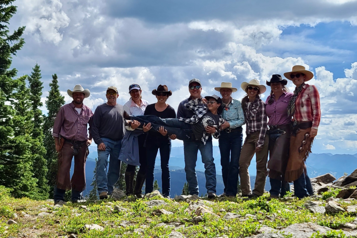 a group of people standing on top of a hill